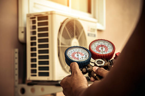 Professional Air Conditioning Service technician working in Osceola, MO